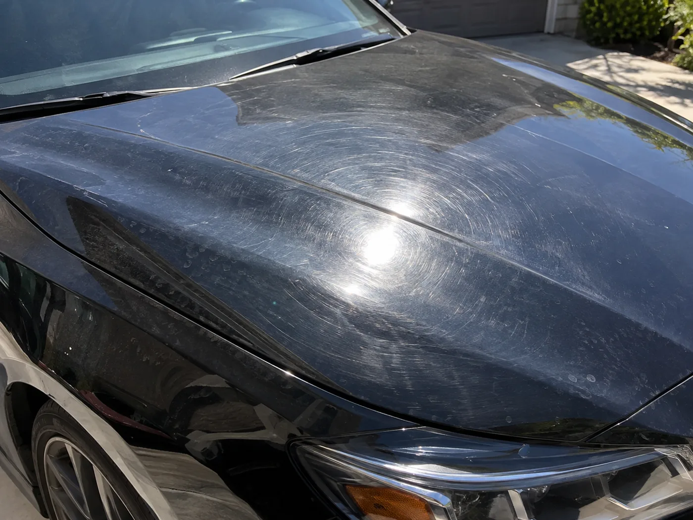 Before: a black hood covered in swirl marks and water spots